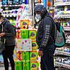 Österreich, Schwechat am 30. März 2020: Kunden mit Mundschutz kaufen in einem Supermarkt ein. Im Kampf gegen die Coronavirus-Pandemie ...