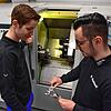 Julian Jurtz und Matthias Hiestand (von links) stehen vor der CNC-Drehmaschine, mit der Ringe und der ...