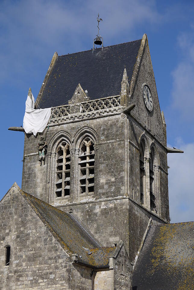 Ein alliierter Soldat landete bei der Invasion in der Normandie auf dem Kirchendach in Sainte-Mère-Église – ihm wird bis heute mit ...