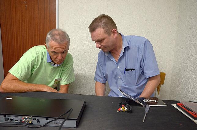 Rainer Conzelmann, einer der Helfer des Reparatur-Cafés hört sich von Toni Ganter die Fehlerbeschreibung an und beobachtet, was der ...