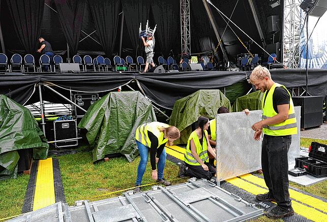Gleichzeitige Auf- und Abbauarbeiten an der Bühne des Seefestivals: Während im Bildhintergrund Techniker die bereits aufgebauten Dinge ...