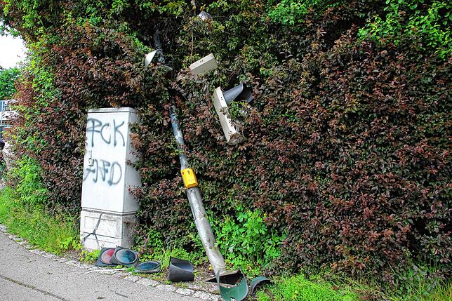 Das Auto reißt die Ampel um.