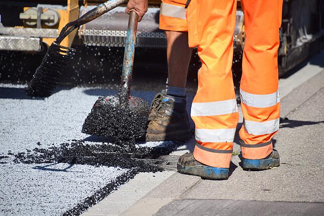 An Gullys ist Handarbeit mit der Schaufel gefragt, damit mit dem Asphalt später alles passt.