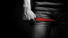 The man with a knife in a hand. Closeup