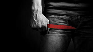 The man with a knife in a hand. Closeup