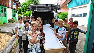 Die Schüler der 4. Klasse der Grundschule Herdwangen. Vor dem Gespräch mit dem Bestatter im Unterricht können sie den Leichenwagen, Sarg ...