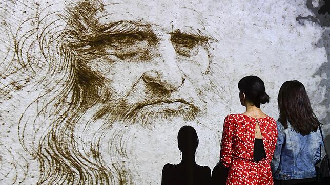Zwei Frauen steht im Mai 2019 in Mailand vor dem Hologramm eines Selbstporträts von Leonardo da Vinci.