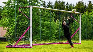 Eine junge Torhüterin steht zwischen den Pfosten des „GirlsGoal“ und wehrt den Ball ab. Das Tor wird bei Fußball-Camps in Heudorf und ...