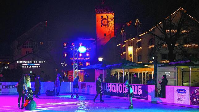 Abendliches Treiben auf der Kunsteisbahn auf dem Waldshuter Viehmarktplatz, im Hintergrund das Untere Tor.