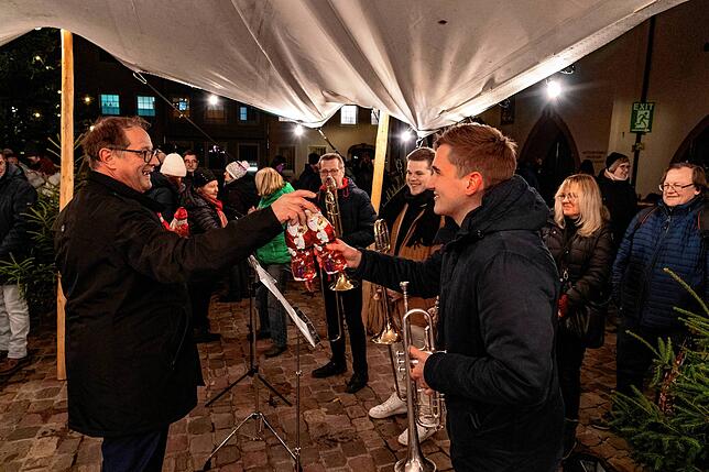 Oberbürgermeister Jürgen Roth bedankt sich bei den Musikern mit Schokoladennikoläusen.