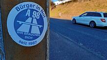 &bdquo;A 98 Wir brauchen dich&ldquo; steht auf einem Aufkleber an einer Laterne in Schwörstadt.
