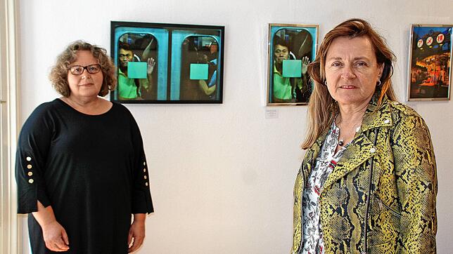 Kulturreferentin Christine Stanzel (links) und Chris Ruetschlin von der f7 Gruppe vor Arbeiten des Fotografen Robin Niedergang aus der ...