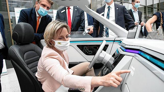 Südwest-Wirtschaftsministerin Nicole Hoffmeister-Kraut (CDU) sitzt bei Marquardt in einem Zukunfts-Cockpit. Im Hintergrund ...