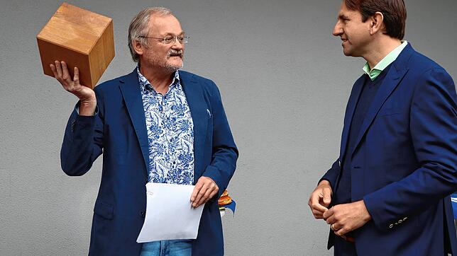 Der Holzwürfel, den Axel Nieburg, Geschäftsführer der Baugenossenschaft Hegau, hier hält, ist die Menge an Holz, die im Landkreis ...