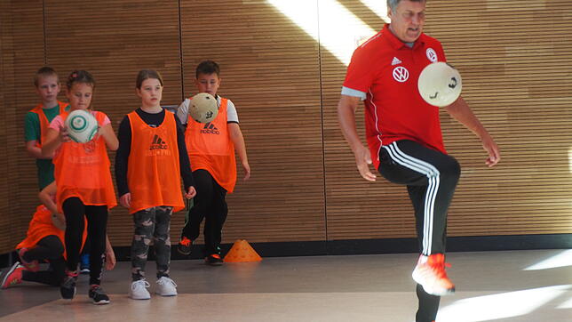 Koordination und Konzentration gehören zum Fußball dazu. Peter Brosi vom DFB-Mobil (rechts) zeigt den Engener Grundschulkindern, wie das ...