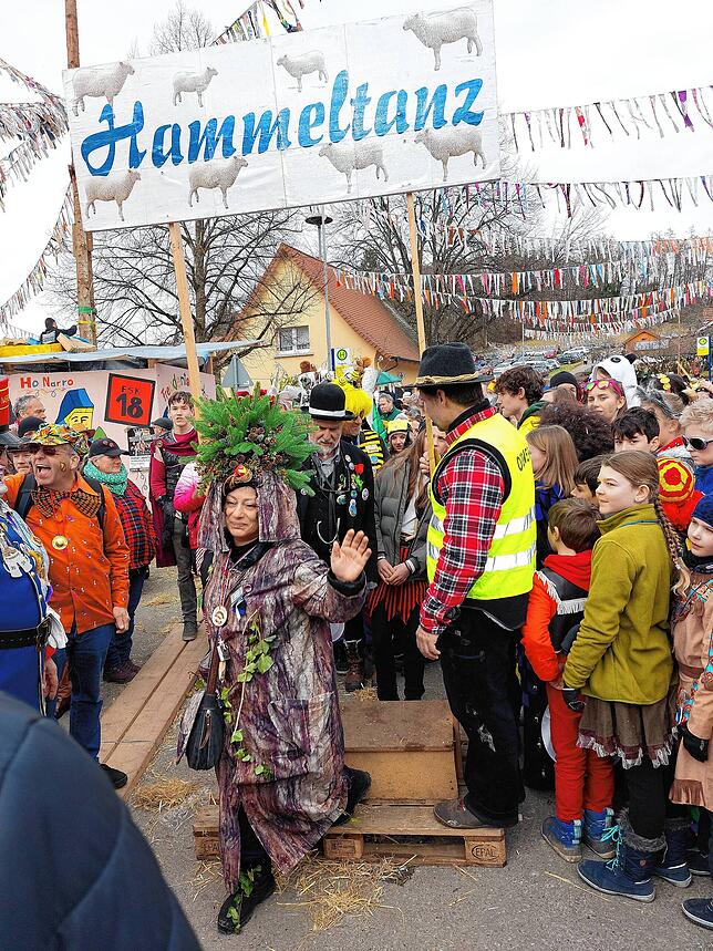 Der Hammeltanz gehört zu den lustigen Attraktionen. Viele Leute machen mit und gehen durch den Holztotbogen.