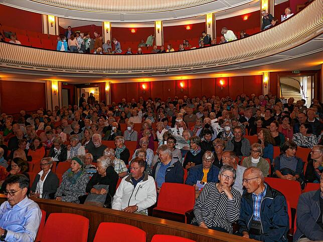 Besucher des Kirchentages verfolgen im Stadttheater den Vortrag von Pater Anselm Grün.
