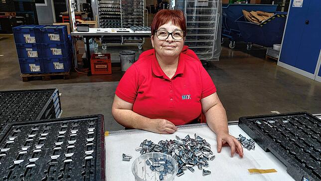 Mitarbeiterin Rosalia Titi kontrolliert Lüftungstasten, die in verschiedene Modelle des Automobilherstellers Mercedes eingebaut werden.