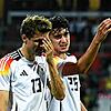 Thomas Müller (l) spricht mit Aleksandar Pavlovic. Pavlovic verpasst die EM – Dortmund-Spieler Emre Can ist nachnominiert.