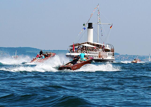 Begleitet von der Riva-Flotte begibt sich das Dampfschiff „Hohentwiel“ auf eine Zeitreise zur Blumeninsel Mainau.