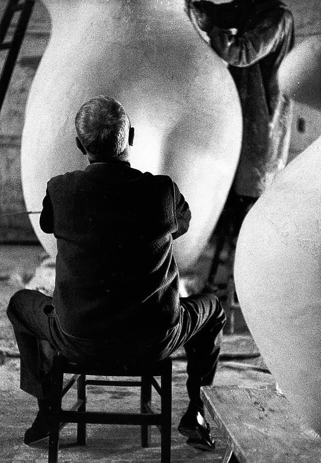 Foto von hinten: Hans Arp arbeitet an der Plastik „Der Wolkenhirt“, 1953.