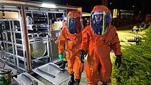Einsatzkräfte der Feuerwehr in Schutzanzügen beim Gefahrgutunfall auf dem Fondium-Gelände.
