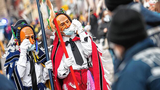 Fasnacht 2021: Rottweiler Narren mit OP-Masken wischen sich beim traditionellen Narrensprung die Tränen aus den Augen.