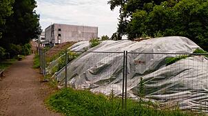 Die Baustelle für die neue Seniorenwohnanlage in Grenzach-Wyhlensorgt für stattliche Hügel mit Erdaushub auf dem Spielplatz und hinter ...
