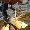 Kreisarchäologe Jürgen Hald dokumentiert das freigelegte Mauerfundaments, das zu einem Vorgängerbau der heutigen Kirche gehörte.
