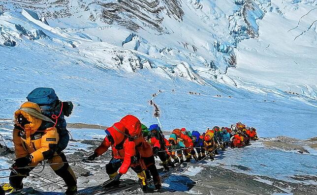 Massen-Alpinismus am Mount Everest. Sherpas machen die schwere Arbeit, Hobby-Bergsteiger wird der Aufstieg – für mehrere ...