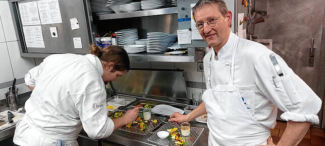 Heinz-Josef Diestel und Chef de Partie Lukas Taschowsky beim Zubereiten eines Desserts.