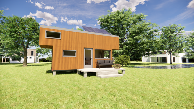In einer Siedlung stehen mehrere Tiny Houses. Die Minihäuser nehmen wenig Grundfläche ein und versiegeln somit weniger Boden.