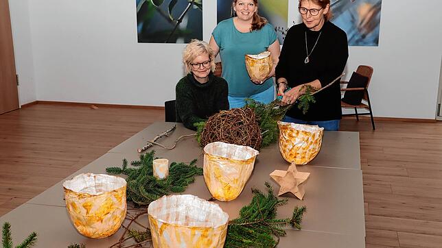 Sandra Storz, Yvonne Hartusch und Elisabeth Paul (von links) bereiten den Adventskalender aus Lichtern vor, der nun am Fenster des ...