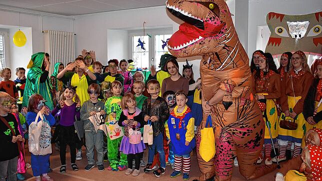 Kleine Dinos wurden von Narrenvater Axel Schmidt im Dinosaurierkostüm überrascht. Rombachwiibli und Elferrat bekamen als Dank für die ...