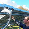 Projektleiter Sören Hilger zeigt an der Solarthermieanlage auf die Stelle, an der das von der Sonne erwärmte Wasser in das System ...