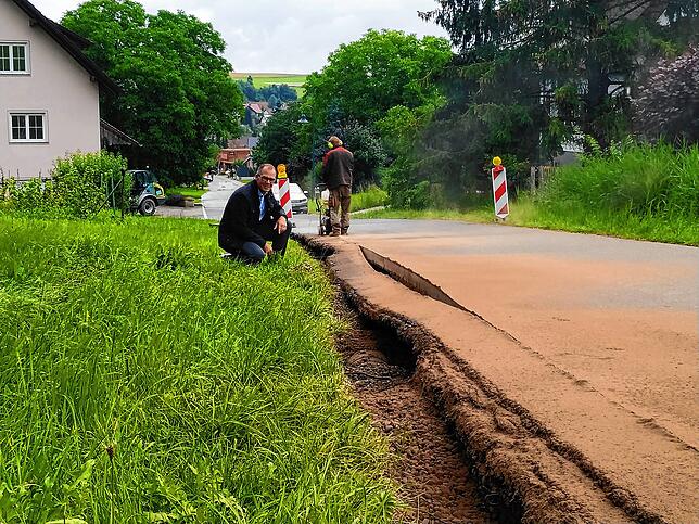 Bürgermeister Thorsten Scigliano an der unterspülten Steinbühlstraße in Mühlingen.