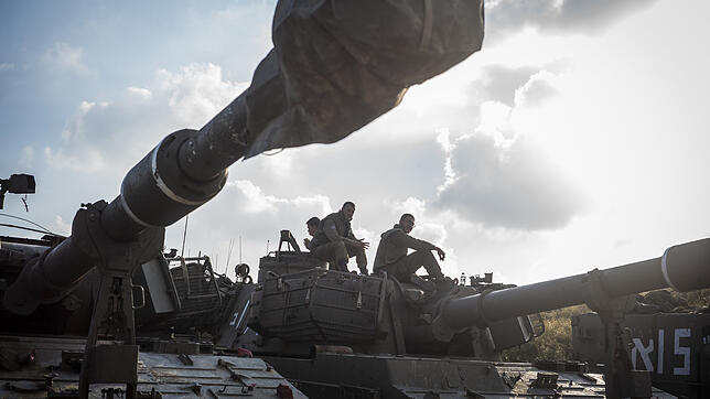 Israelische Soldaten sitzen auf einem artilleriegepanzerten Fahrzeug, das in der Nähe der Grenze zwischen Israel und Gaza eingesetzt ...