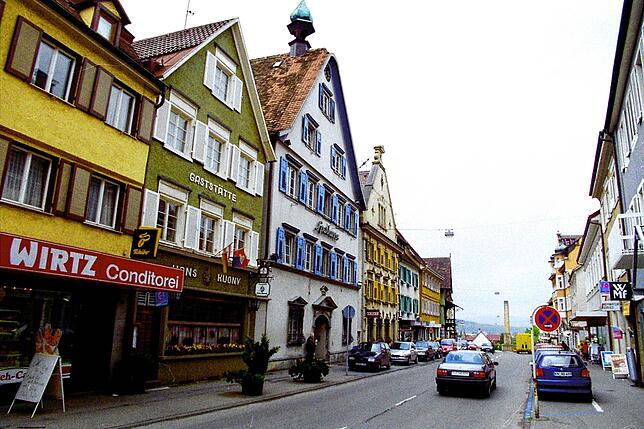 Die Hauptstraße war früher in beide Richtungen offen. Die Bäckerei Wirtz ist heute die Bäckerei Ainser und die grüne Gaststätte Hans ...