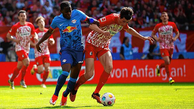 Leipzigs Castello Lukeba (l) und Freiburgs Merlin Röhl im Duell.