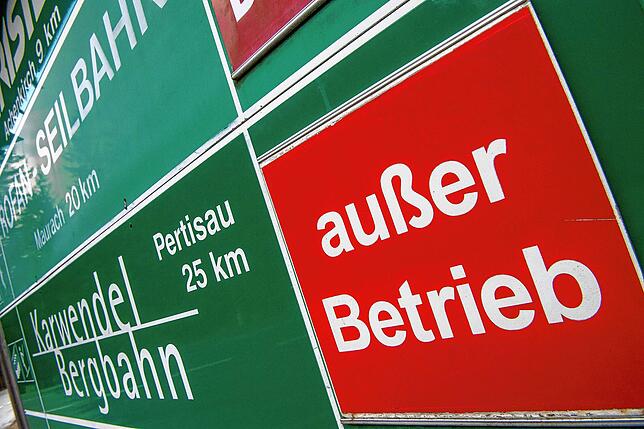 „Außer Betrieb“ steht auf einem Schild, auf dem diverse Bahnen und Lifte zu Skigebieten in Tirol aufgeführt sind.