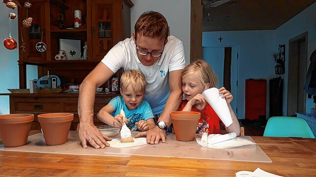Familienprojekt Trommel: gut Kleister auf das Butterbrotpapier pinseln und ab damit auf den Tontopf.
