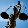 Eine Statue der Justitia hält eine Waage in der Hand (Symbolbild). In der Schweiz hat ein falscher Anwalt viel Geld kassiert.