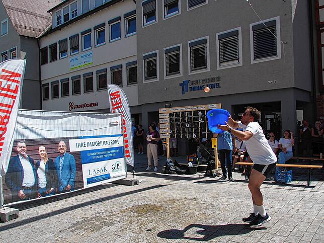 Noch ist die Wasserbombe in der Luft. Sie muss nun mit dem Eimer gefangen werden.