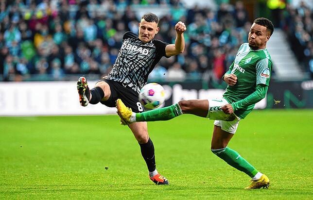 Werders Felix Agu (r) kämpft gegen Freiburgs Maximilian Eggestein um den Ball.