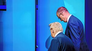 Bundeskanzler Friedrich Merz (CDU, r), und US-Präsident Donald Trump unterhalten sich beim Nato-Gipfel nach dem Familienfoto. Merz will ...