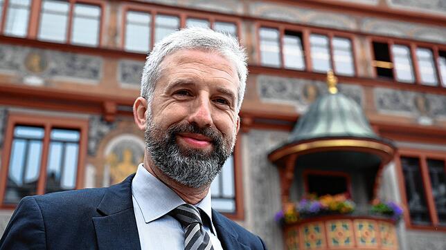 Boris Palmer (parteilos), Tübingens Oberbürgermeister, lächelt in der Innenstadt in die Kamera des Fotografen. Foto: Silas Stein, dpa