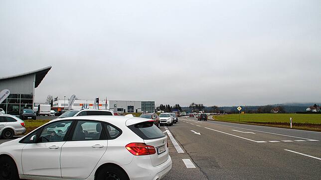 Eine lange Autoschlange bildet sich vor dem Impfcenter.