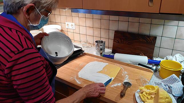 Über die Schulter geschaut: Anita Brockhaus verteilt Eischnee-Masse auf den Butterstengeln, die schon ihre Mutter gebacken hat.
