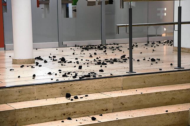 Bei einer Aktion der Organisation „Lützerath bleibt“ kippte ein Aktivist Kohle im Foyer der Sparkasse aus.