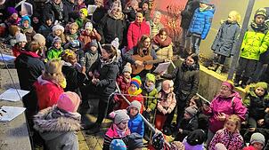 Die Kinder des Waldkindergartens und des Dangstetter Kindergartens singen gemeinsam auf der Treppe beim Weihnachtsmarkt in Dangstetten. ...